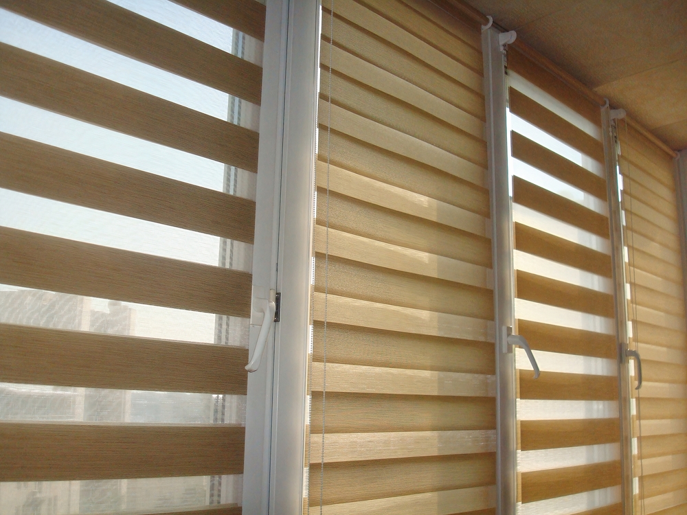 Double,roller,blinds,closeup,on,the,window,in,the,interior.