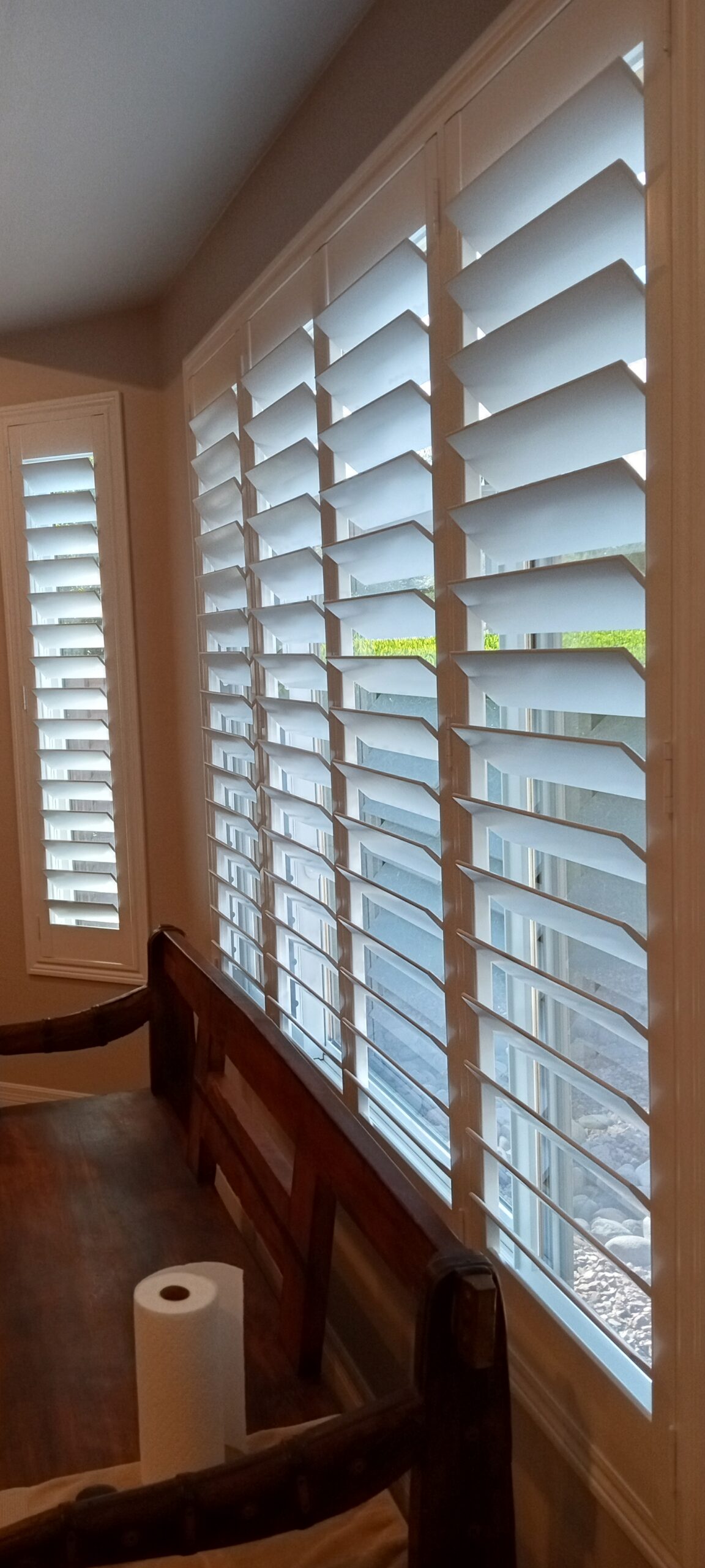 Plantation shutters installed on a row of dining room windows