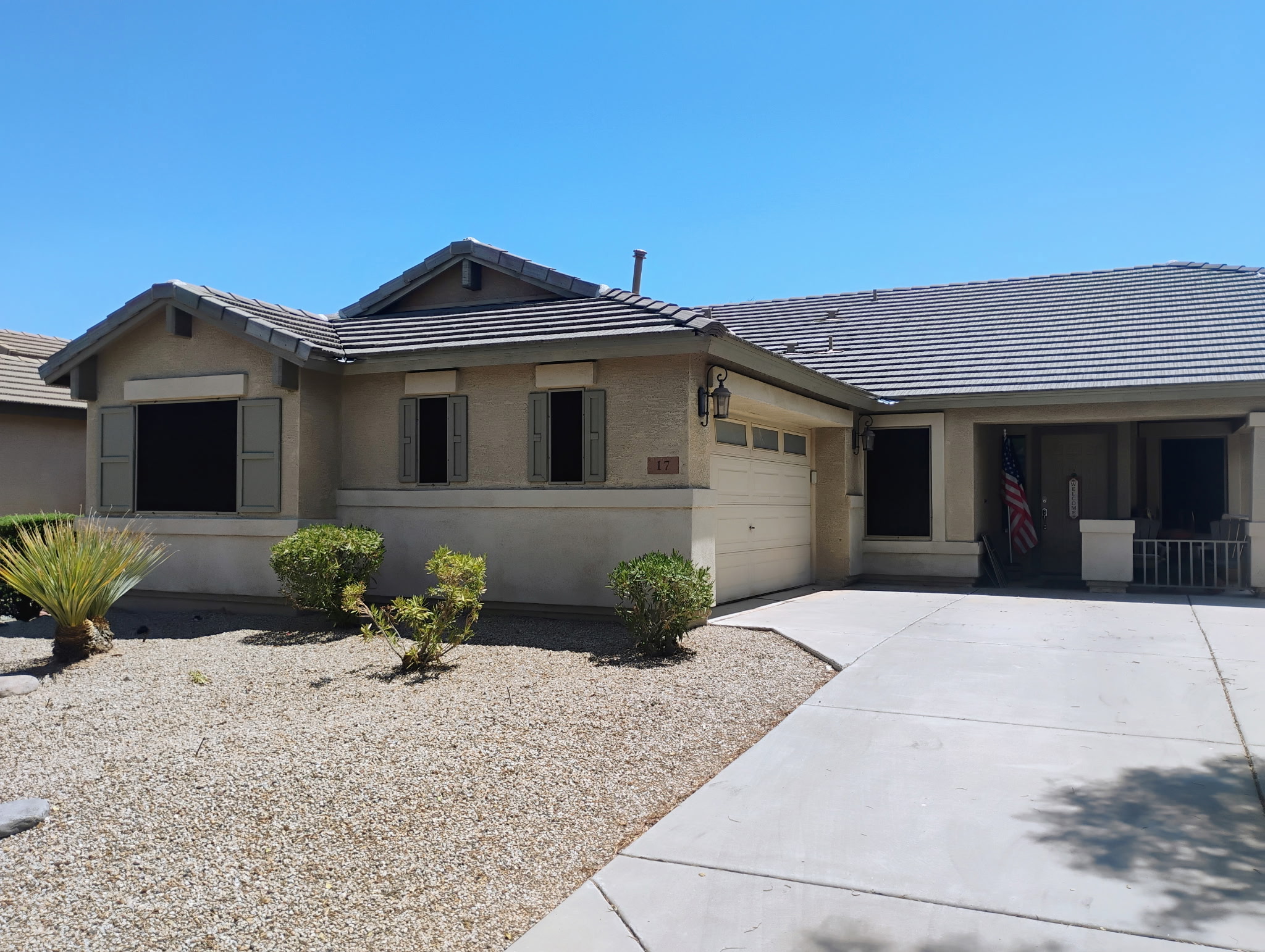 Single-story Mesa home with dark exterior sun screens covering multiple windows