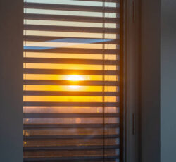 Sun Seen Through A Window With External Venetian Blinds