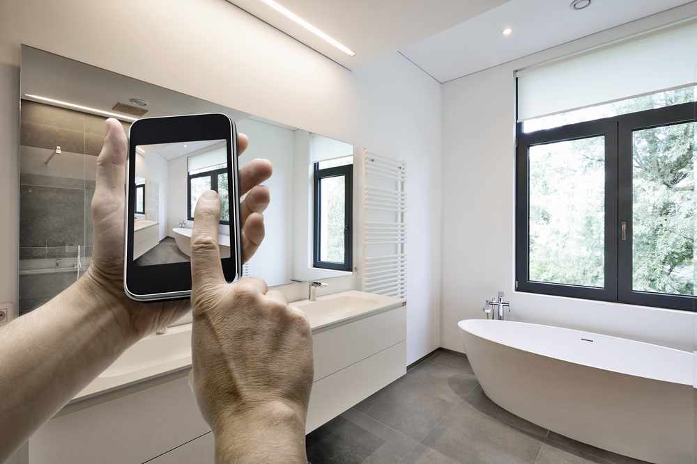 Motorized shades installed on a large window, raised partway to control light